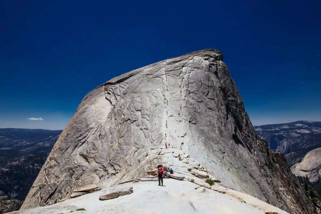 Hikers Ascending Half Dome Cables
