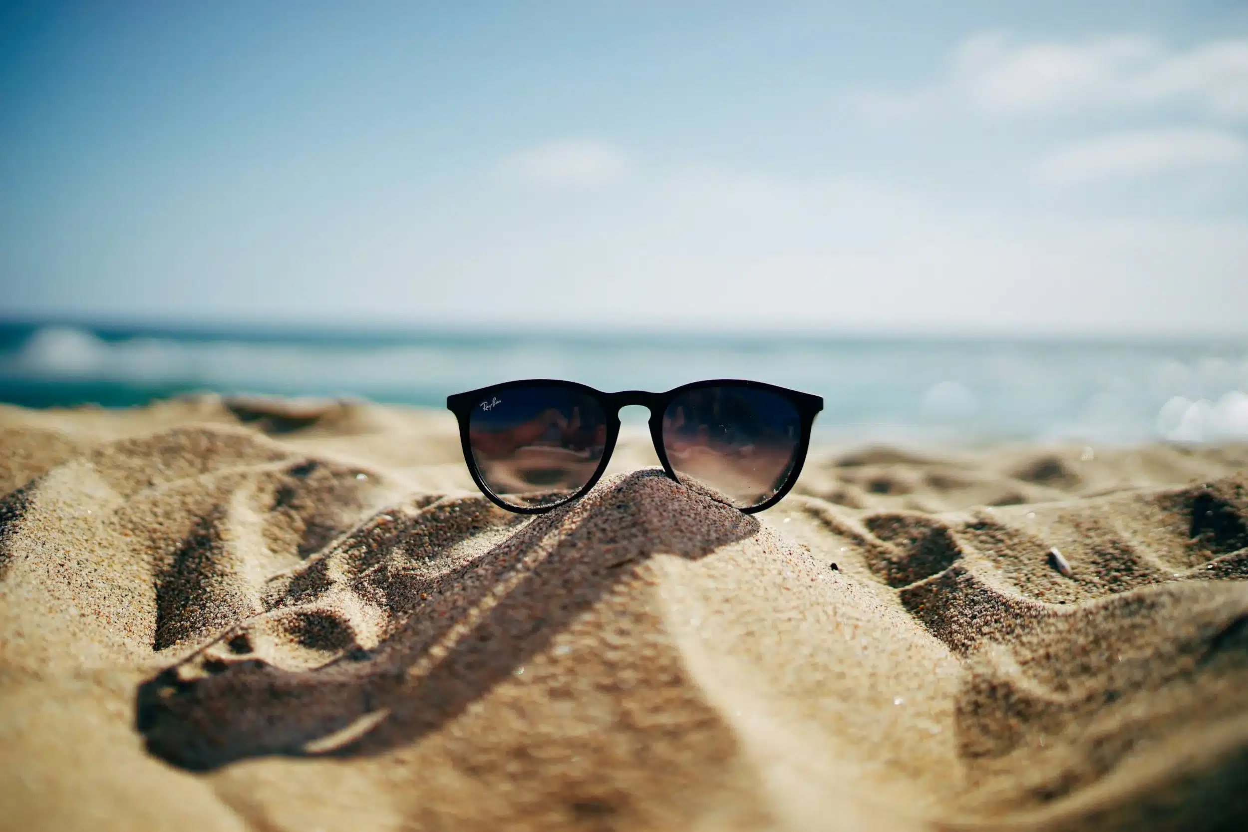 Stylish Sunglasses on a Sandy Beach